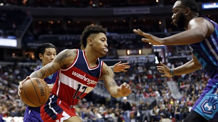 Apr 10, 2016; Washington, DC, USA; Washington Wizards forward Kelly Oubre Jr. (12) dribbles the ball as Charlotte Hornets center Al Jefferson (25) defends in the fourth quarter at Verizon Center. The Wizards won 113-98. Mandatory Credit: Geoff Burke-USA TODAY Sports