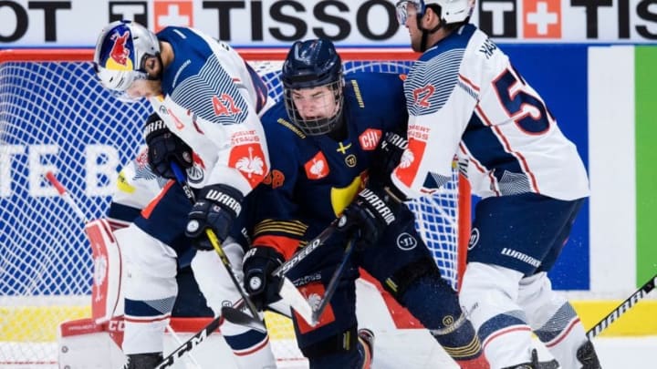 Djurgarden’s Alexander Holtz (C) is squeezed by Munich’s Yasin Ehliz (L) and Patrick Hager during the quarterfinal between Djurgarden Hockey and Red Bull Munich at the Champions Hockey League is a European ice hockey tournament on December 3, 2019 in Stockholm, Sweden. – during the quarterfinal between Djurgarden Hockey and Red Bull Munich at the Champions Hockey League is a European ice hockey tournament on December 3, 2019 in Stockholm, Sweden. (Photo by Erik SIMANDER / TT NEWS AGENCY / AFP) / Sweden OUT (Photo by ERIK SIMANDER/TT NEWS AGENCY/AFP via Getty Images)