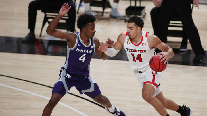 Jan 5, 2021; Lubbock, Texas, USA; Texas Tech Red Raiders forward Marcus Santos-Silva (14) works the ball against Kansas State Wildcats forward Seryee Lewis (4) in the second half at United Supermarkets Arena. Mandatory Credit: Michael C. Johnson-USA TODAY Sports