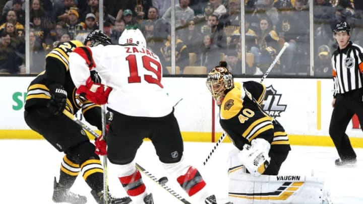 BOSTON, MA - MARCH 02: Boston Bruins goalie Tuukka Rask (40) watches the puck as Boston Bruins right defenseman Brandon Carlo (25) ties up New Jersey Devils center Travis Zajac (19) during a game between the Boston Bruins and the New Jersey Devils on March 2, 2019, at TD Garden in Boston, Massachusetts. (Photo by Fred Kfoury III/Icon Sportswire via Getty Images)