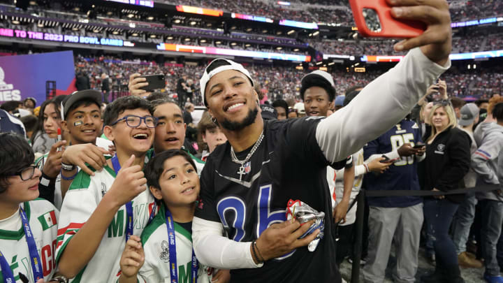 Feb 5, 2023; Paradise, Nevada, USA; NFC running back Saquon Barkley of the New York Giants (26) takes a selfie with NFL Flag team Mexico at the 2023 Pro Bowl at Allegiant Stadium. Mandatory Credit: Lucas Peltier-USA TODAY Sports