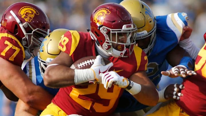 PASADENA, CALIFORNIA - NOVEMBER 17: Running back Vavae Malepeai #29 of the USC Trojans pushes through a tackle during the second half of a football game at Rose Bowl on November 17, 2018 in Pasadena, California. (Photo by Katharine Lotze/Getty Images)