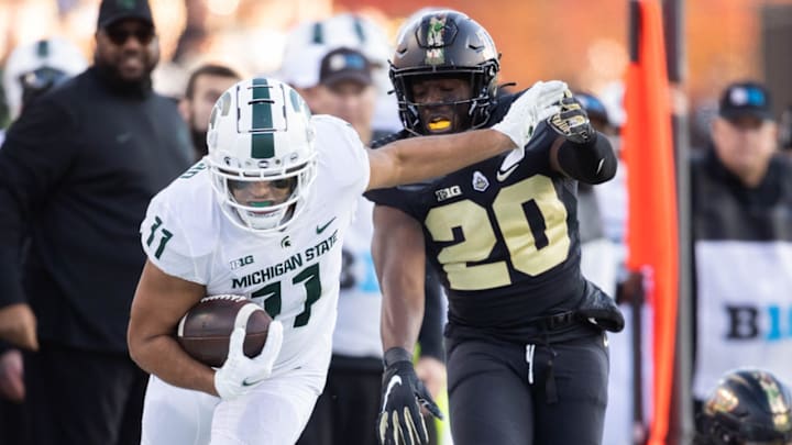 Nov 6, 2021; West Lafayette, Indiana, USA; Michigan State Spartans running back Connor Heyward (11) runs with the ball while Purdue Boilermakers linebacker O.C. Brothers (20) defends in the first half at Ross-Ade Stadium. Mandatory Credit: Trevor Ruszkowski-USA TODAY Sports