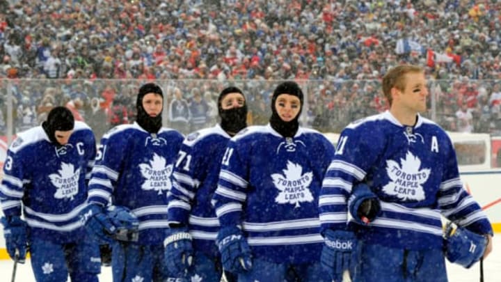 TORONTO , ON - JANUARY 1: The Toronto Maple Leafs stand for the singing of the national anthem before action against the Detroit Red Wings during NHL game action during the 2014 Bridgestone NHL Winter Classic January 1, 2014 at Michigan Stadium in Ann Arbor, Michigan. (Photo by Graig Abel/NHLI via Getty Images)