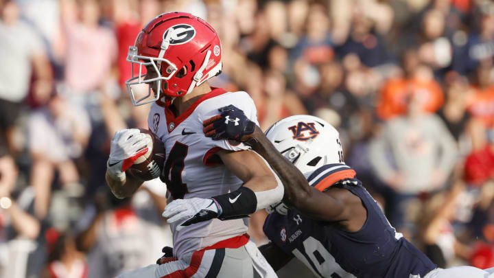 Oct 9, 2021; Auburn, Alabama, USA; Georgia Bulldogs wide receiver Ladd McConkey (84) drags Auburn Tigers cornerback Nehemiah Pritchett (18) into the end zone during the third quarter at Jordan-Hare Stadium. Mandatory Credit: John Reed-USA TODAY Sports