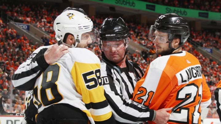 PHILADELPHIA, PA - APRIL 15: Linesman Derek Nansen #70 gets between Kris Letang #58 of the Pittsburgh Penguins and Scott Laughton #21 of the Philadelphia Flyers during the second period in Game Three of the Eastern Conference First Round during the 2018 NHL Stanley Cup Playoffs at the Wells Fargo Center on April 15, 2018 in Philadelphia, Pennsylvania. (Photo by Bruce Bennett/Getty Images)