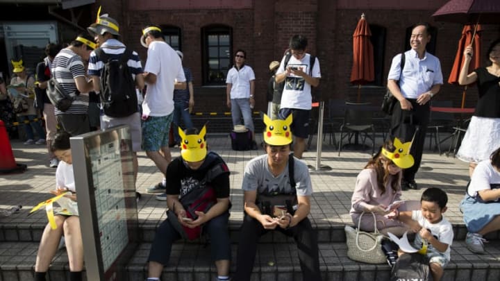 YOKOHAMA, JAPAN - AUGUST 09: People play Nintendo Co.'s Pokemon Go augmented reality game on their smartphones during the Pikachu Outbreak event hosted by The Pokemon Co. on August 9, 2017 in Yokohama, Kanagawa, Japan. A total of 1, 500 Pikachus appear at the city's landmarks in the Minato Mirai area aiming to attract visitors and tourists to the city. The event will be held through until August 15. (Photo by Tomohiro Ohsumi/Getty Images)