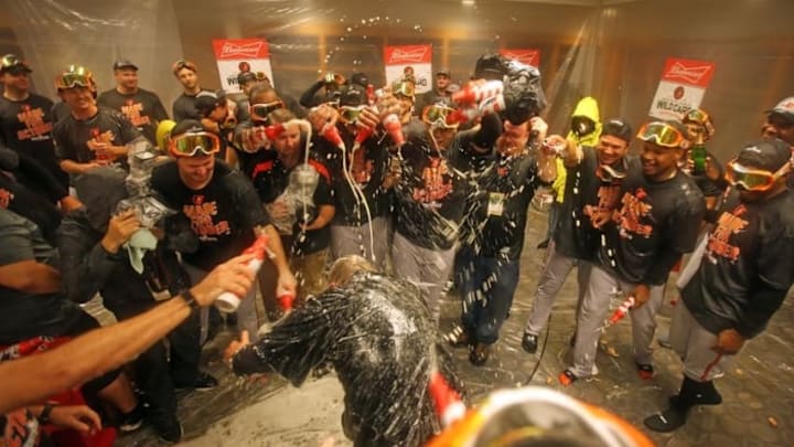 Oct 2, 2016; Bronx, NY, USA; The Baltimore Orioles spray manager Buck Showalter with champagne after beating the New York Yankees 5-2 to clinch an American League Wild Card playoff spot at Yankee Stadium. Mandatory Credit: Danny Wild-USA TODAY Sports