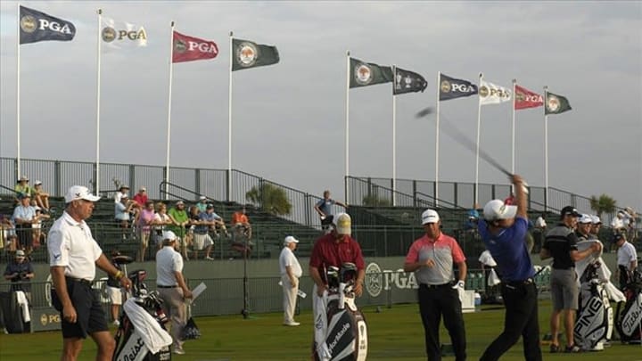 Aug, 10, 2012; Kiawah Island, SC, USA; (From left) Steve Williams watches as Adam Scott (AUS) works at the practice range during the 2nd Round of the 94th PGA Championship at The Ocean Course of the Kiawah Island Golf Resort. Mandatory Credit: Bruce Chapman-USA TODAY Sports