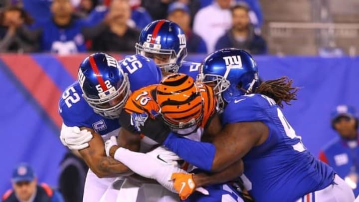 Nov 14, 2016; East Rutherford, NJ, USA; Cincinnati Bengals wide receiver A.J. Green (18) is tackled after making a catch during the first half of their game against the New York Giants at MetLife Stadium. Mandatory Credit: Ed Mulholland-USA TODAY Sports