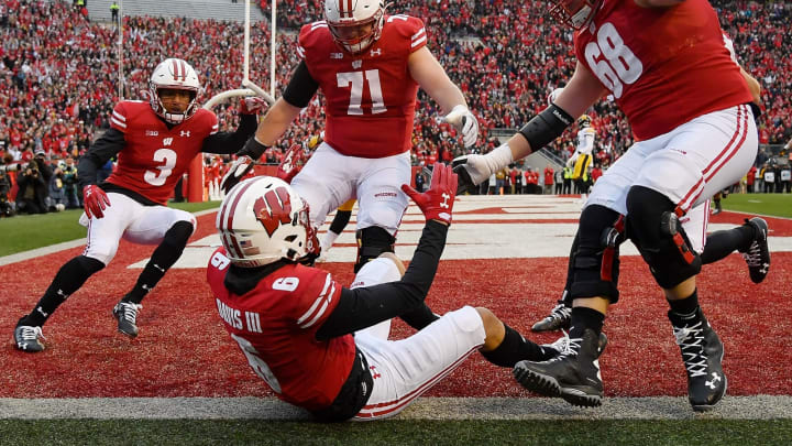MADISON, WISCONSIN – NOVEMBER 09: Danny Davis III #6 of the Wisconsin Badgers celebrates with Kendric Pryor #3, Cole Van Lanen #71 and David Moorman #68 of the Wisconsin Badgers after scoring a touchdown in the first half against the Iowa Hawkeyes at Camp Randall Stadium on November 09, 2019 in Madison, Wisconsin. (Photo by Quinn Harris/Getty Images)