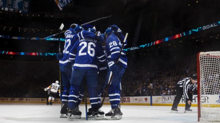 TORONTO, ON - NOVEMBER 6: Connor Brown #28 of the Toronto Maple Leafs celebrates his goal with teammates Par Lindholm #26 and Igor Ozhiganov #92 during the first period against the Vegas Golden Knights at the Scotiabank Arena on November 6, 2018 in Toronto, Ontario, Canada. (Photo by Mark Blinch/NHLI via Getty Images)