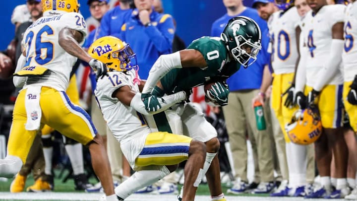 Michigan State wide receiver Keon Coleman is tackled by Pittsburgh defensive back M.J. Devonshire during the second half of the 31-21 win over Pittsburgh in the Peach Bowl at the Mercedes-Benz Stadium in Atlanta on Thursday, Dec. 30, 2021.