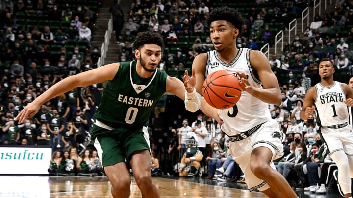 Nov 20, 2021; East Lansing, Michigan, USA; Michigan State Spartans player Jaden Akins (3) past Eastern Michigan Eagles player Kevin-David Rice (0) at Jack Breslin Student Events Center. Mandatory Credit: Dale Young-USA TODAY Sports