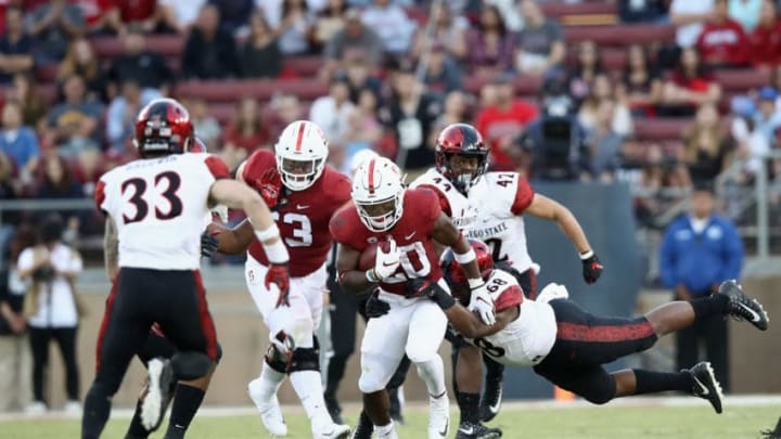 PALO ALTO, CA - AUGUST 31: Bryce Love #20 of the Stanford Cardinal is tackled by Myles Cheatum #68 of the San Diego State Aztecs at Stanford Stadium on August 31, 2018 in Palo Alto, California. (Photo by Ezra Shaw/Getty Images)