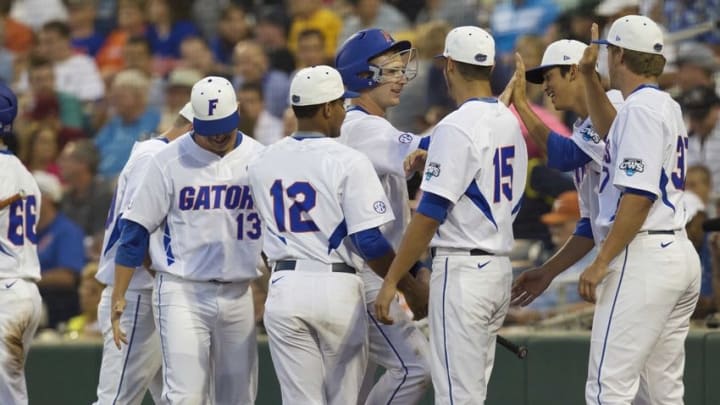 Jun 13, 2015; Omaha, NE, USA; Florida Gators outfielder Buddy Reed (23) drives in a run in the fourth inning against the Miami Hurricanes in the 2015 College World Series at TD Ameritrade Park. Mandatory Credit: Steven Branscombe-USA TODAY Sports