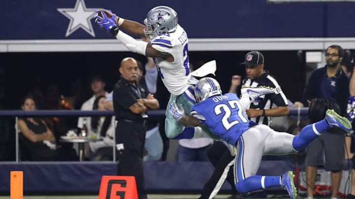 ARLINGTON, TX - DECEMBER 26: Ezekiel Elliott #21 of the Dallas Cowboys dives toward the goal line to score a touchdown as Glover Quin #27 of the Detroit Lions defends during the first half at AT&T Stadium on December 26, 2016 in Arlington, Texas. (Photo by Ronald Martinez/Getty Images)