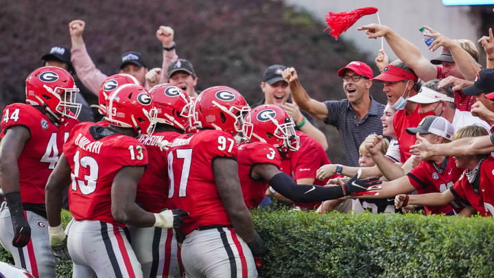 Oct 10, 2020; Athens, Georgia, USA; Georgia Bulldogs players react with fans in the end zone after linebacker Monty Rice (32) (in crowd of players) returns a fumble for a touchdown against the Tennessee Volunteers during the second half at Sanford Stadium. Mandatory Credit: Dale Zanine-USA TODAY Sports