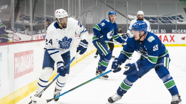 VANCOUVER, BC - APRIL 18: Wayne Simmonds #24 of the Toronto Maple Leafs tries to get past Bo Horvat #53 of the Vancouver Canucks during NHL hockey action at Rogers Arena on April 17, 2021 in Vancouver, Canada. (Photo by Rich Lam/Getty Images)