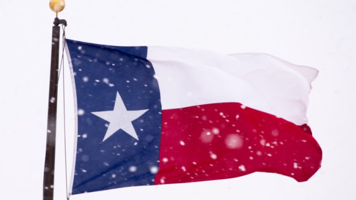 LUBBOCK, TEXAS - DECEMBER 27: The Texas state flag is battered by high wind and heavy snow on December 27, 2015 in Lubbock, Texas. Coming on the heels of several strong tornadoes, some northern parts of Texas are experiencing blizzard conditions with wind gusts up to 50 mph and as much as 13 inches of snow forecast. (Photo by John Weast/Getty Images)