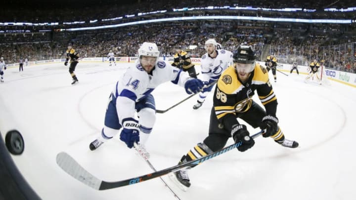 BOSTON, MA - MAY 02: Tampa Bay Lightning left wing Chris Kunitz (14) and Boston Bruins right defenseman Kevan Miller (86) vie for the puck along the glass during Game 3 of the Second Round between the Boston Bruins and the Tampa Bay Lightning on May 2, 2018, at TD Garden in Boston, Massachusetts. The Lightning defeated the Bruins 4-1. (Photo by Fred Kfoury III/Icon Sportswire via Getty Images)