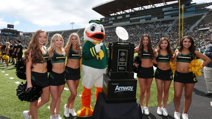 Apr 30, 2016; Eugene, OR, USA; Oregon Ducks cheerleaders and mascot stand next to the American Football Coaches Association (AFCA) Coaches trophy at half time at the Oregon Ducks spring football game at Autzen Stadium. Mandatory Credit: Scott Olmos-USA TODAY Sportsat Autzen Stadium. Mandatory Credit: Scott Olmos-USA TODAY Sports