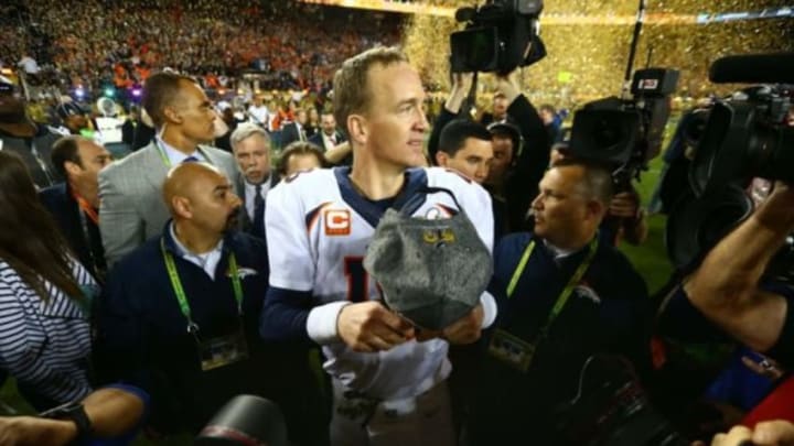 Feb 7, 2016; Santa Clara, CA, USA; Denver Broncos quarterback Peyton Manning (18) is surrounded by photographers on the field as he celebrates defeating the Carolina Panthers in Super Bowl 50 at Levi
