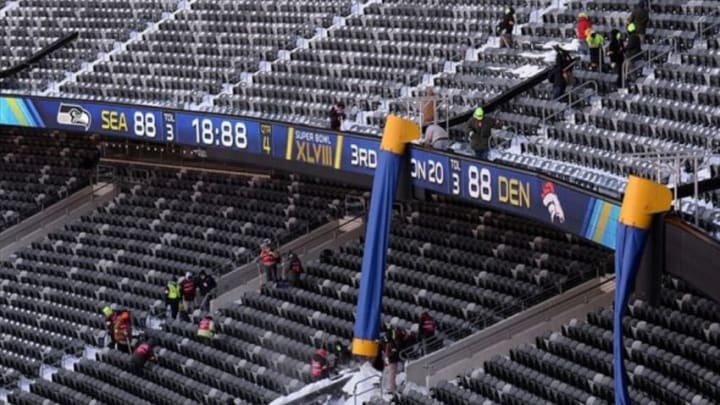 Jan 22, 2014; East Rutherford, NJ, USA; A general view as stadium workers clean snow stands during the Super Bowl XLVIII stadium preparations press conference at MetLife Stadium. Mandatory Credit: Joe Camporeale-USA TODAY Sports