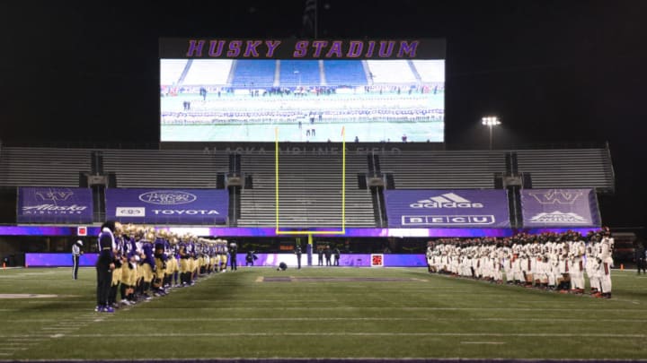 SEATTLE, WASHINGTON - NOVEMBER 14: The Washington Huskies and Oregon State Beavers stand before each other while linking arms to show support towards racial equality before their game at Husky Stadium on November 14, 2020 in Seattle, Washington. (Photo by Abbie Parr/Getty Images)