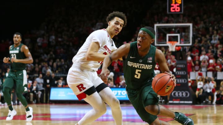 PISCATAWAY, NJ - NOVEMBER 30: Cassius Winston #5 of the Michigan State Spartans drives to the basket as Caleb McConnell #22 of the Rutgers Scarlet Knights defends during the second half of a college basketball game at the Rutgers Athletic Center on November 30, 2018 in Piscataway, New Jersey. Michigan State defeated Rutgers 78-67. (Photo by Rich Schultz/Getty Images,)