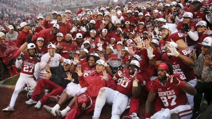 Dec 3, 2016; Norman, OK, USA; Oklahoma Sooners coaches and players take a team photo with the Big 12 championship trophy after the game against the Oklahoma State Cowboys at Gaylord Family - Oklahoma Memorial Stadium. Mandatory Credit: Kevin Jairaj-USA TODAY Sports