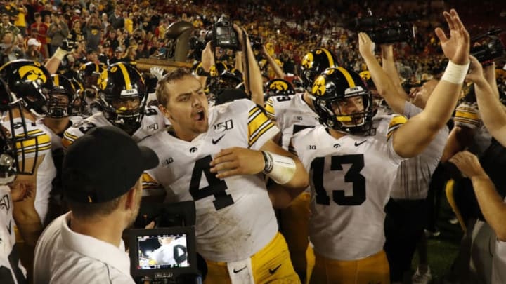 AMES, IA - SEPTEMBER 14: Quarterback Nate Stanley #4 , and wide receiver Henry Marchese #13 of the Iowa Hawkeyes celebrate with teammates winning the Iowa Corn Cy-Hawk Trophy 18-17 over the Iowa State Cyclones at Jack Trice Stadium on September 14, 2019 in Ames, Iowa. The Iowa Hawkeyes won 18-17 over the Iowa State Cyclones. (Photo by David Purdy/Getty Images)