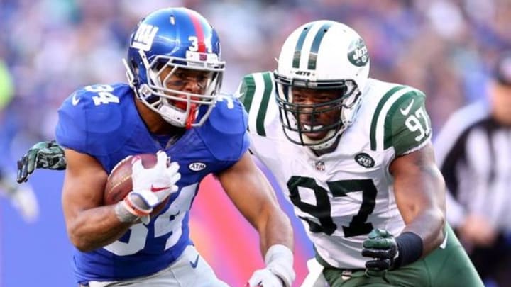 Dec 6, 2015; East Rutherford, NJ, USA; New York Giants running back Shane Vereen (34) runs by New York Jets linebacker Calvin Pace (97) during the fourth quarter at MetLife Stadium. The Jets defeated the Giants 23-20 in overtime. Mandatory Credit: Brad Penner-USA TODAY Sports