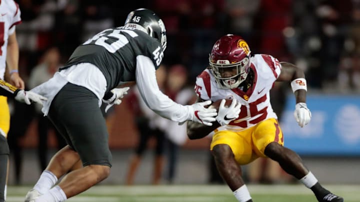 PULLMAN, WA - SEPTEMBER 29: Ronald Jones II #25 of the USC Trojans moves the ball against Logan Tago #45 of the Washington State Cougars in the second half at Martin Stadium on September 29, 2017 in Pullman, Washington. Washington State defeated USC 30-27. (Photo by William Mancebo/Getty Images) PULLMAN, WA - SEPTEMBER 29: Ronald Jones II #25 of the USC Trojans moves the ball against Logan Tago #45 of the Washington State Cougars in the second half at Martin Stadium on September 29, 2017 in Pullman, Washington. Washington State defeated USC 30-27. (Photo by William Mancebo/Getty Images)