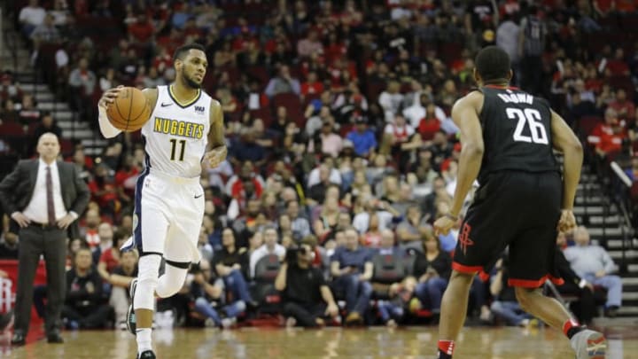 HOUSTON, TX - FEBRUARY 09: Monte Morris #11 of the Denver Nuggets brings the ball down the court defended by Markel Brown #26 of the Houston Rockets in the second half at Toyota Center on February 9, 2018 in Houston, Texas. NOTE TO USER: User expressly acknowledges and agrees that, by downloading and or using this Photograph, user is consenting to the terms and conditions of the Getty Images License Agreement. (Photo by Tim Warner/Getty Images)