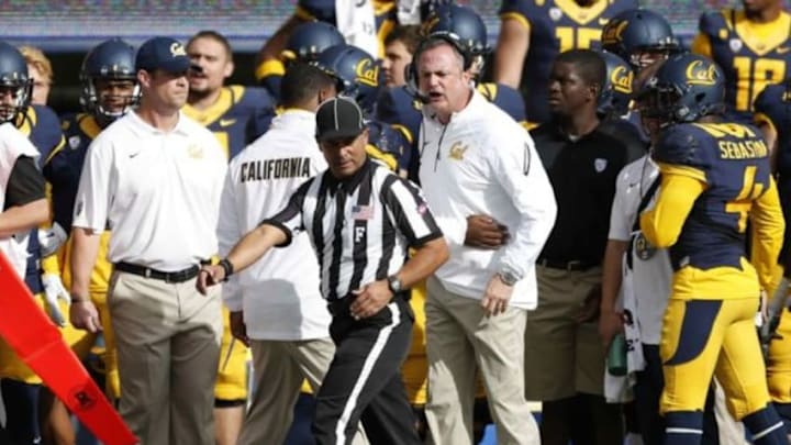 Nov 22, 2014; Berkeley, CA, USA; California Golden Bears head coach Sonny Dykes disagrees with the referee on a player ejection call during the first quarter against the Stanford Cardinal at Memorial Stadium. Mandatory Credit: Bob Stanton-USA TODAY Sports