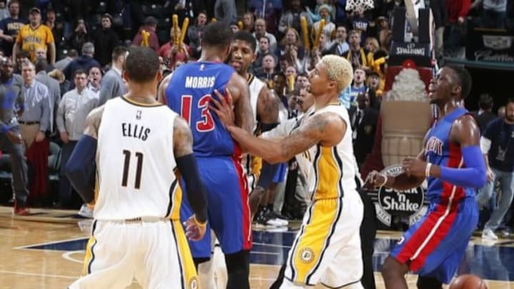 Jan 2, 2016; Indianapolis, IN, USA; Indiana Pacers forward Paul George (13) gets into an argument with Detroit Pistons forward Marcus Morris (13) while guard George Hill (3) tries to push Morris away at the end of the game at Bankers Life Fieldhouse. Indiana defeats Detroit 94-82. Mandatory Credit: Brian Spurlock-USA TODAY Sports