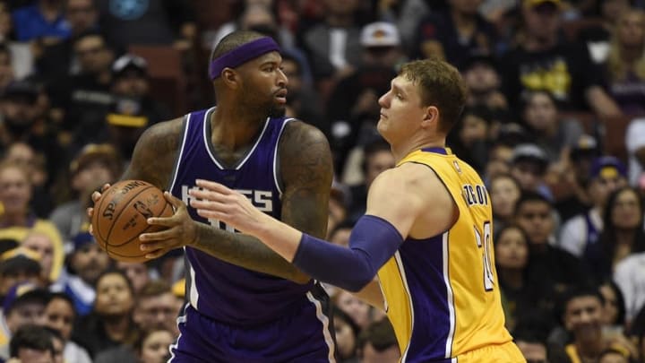 Oct 4, 2016; Anaheim, CA, USA; Sacramento Kings center DeMarcus Cousins (left) handles the ball defended by Los Angeles Lakers center Timofey Mozgov (right) during the first half at Honda Center. Mandatory Credit: Kelvin Kuo-USA TODAY Sports