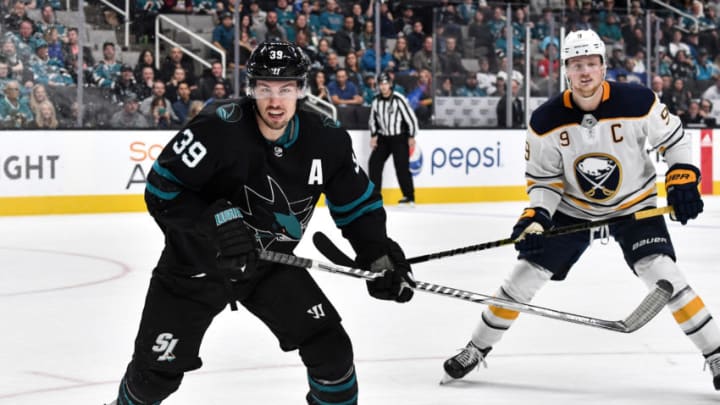 SAN JOSE, CA - OCTOBER 18: (L-R) Logan Couture #39 of the San Jose Sharks battles for the puck with Jack Eichel #9 of the Buffalo Sabres at SAP Center on October 18, 2018 in San Jose, California (Photo by Brandon Magnus/NHLI via Getty Images)