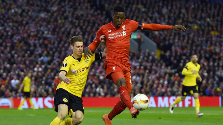 LIVERPOOL, ENGLAND – APRIL 14: Divock Origi of Liverpool challenges for the ball with Lukasz Piszczek of Borussia Dortmund during the UEFA Europa League quarter final, second leg match between Liverpool and Borussia Dortmund at Anfield on April 14, 2016 in Liverpool, United Kingdom. (Photo by Shaun Botterill/Getty Images)