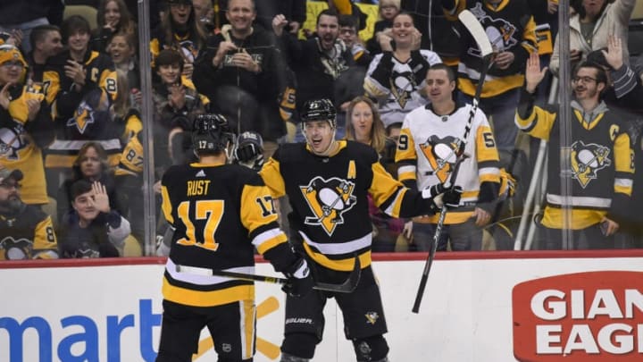 PITTSBURGH, PA - DECEMBER 30: Pittsburgh Penguins Center Evgeni Malkin (71) celebrates his goal with Pittsburgh Penguins Right Wing Bryan Rust (17) during the second period in the NHL game between the Pittsburgh Penguins and the Ottawa Senators on December 30, 2019, at PPG Paints Arena in Pittsburgh, PA. (Photo by Jeanine Leech/Icon Sportswire via Getty Images)
