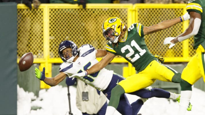 Nov 14, 2021; Green Bay, Wisconsin, USA; Seattle Seahawks wide receiver Tyler Lockett (16) dives trying to catch a pass as Green Bay Packers cornerback Eric Stokes (21) defends during the second quarter at Lambeau Field. Mandatory Credit: Jeff Hanisch-USA TODAY Sports