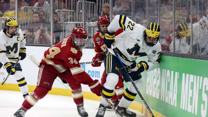 BOSTON, MASSACHUSETTS - APRIL 07: Carter Mazur #34 of the Denver Pioneers defends Owen Power #22 of the Michigan Wolverines during the second period of the Frozen Four semifinal game between the Michigan Wolverines and Denver Pioneers at TD Garden on April 07, 2022 in Boston, Massachusetts. (Photo by Maddie Meyer/Getty Images)