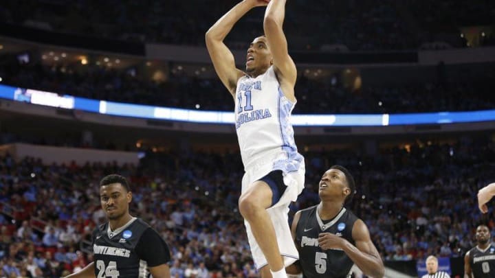 Mar 19, 2016; Raleigh, NC, USA; North Carolina Tar Heels forward Brice Johnson (11) dunks the ball in front of Providence Friars forward Rodney Bullock (5) and guard Kyron Cartwright (24) in the first half during the second round of the 2016 NCAA Tournament at PNC Arena. Mandatory Credit: Geoff Burke-USA TODAY Sports