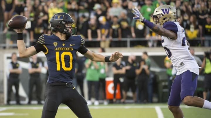 Oct 8, 2016; Eugene, OR, USA; University of Oregon Ducks quarterback Justin Herbert (10) throws the ball in front of University of Washington Huskies defensive back Sidney Jones (26) during the second quarter at Autzen Stadium. The Huskies won 70-21. Mandatory Credit: Troy Wayrynen-USA TODAY Sports