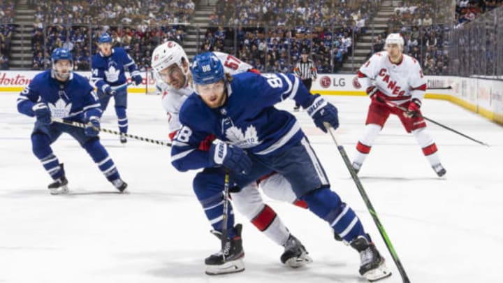 William Nylander #88 of the Toronto Maple Leafs plays the puck against Trevor van Riemsdyk #57 of the Carolina Hurricanes  (Photo by Mark Blinch/NHLI via Getty Images)
