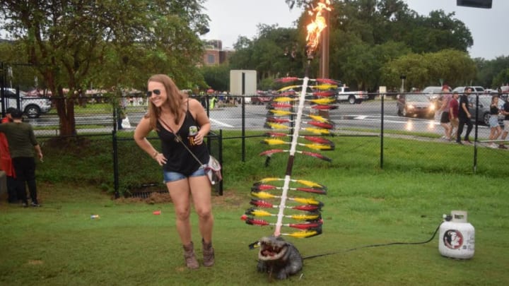 An FSU fan poses with a burning spear through an alligator's head before the start of the Florida State versus Virginia Tech game on Monday.Dsc 0495