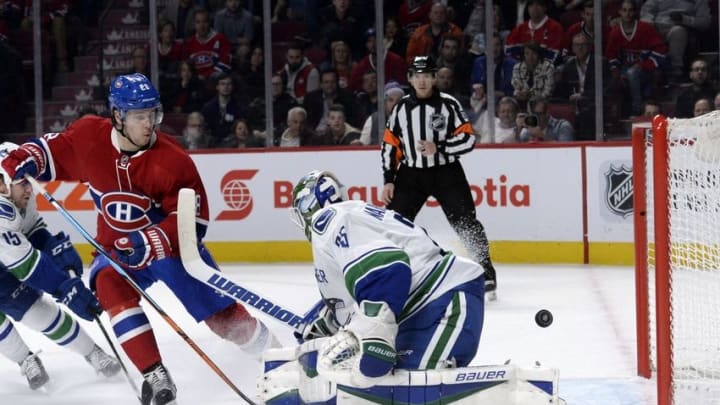Nov 16, 2015; Montreal, Quebec, CAN; Montreal Canadiens defenseman Nathan Beaulieu (28) watches the puck go in the net behind Vancouver Canucks goalie Jacob Markstrom (25) for the tying goal scored by teammate Tomas Fleischmann (not pictured) during the third period at the Bell Centre. Mandatory Credit: Eric Bolte-USA TODAY Sports