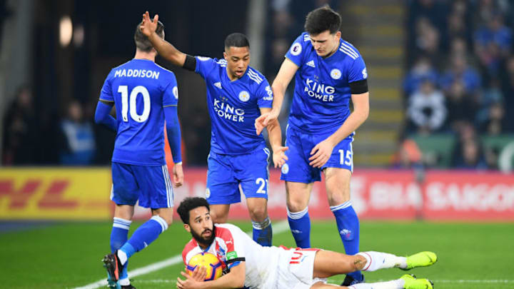 LEICESTER, ENGLAND - FEBRUARY 23: Andros Townsend of Crystal Palace reacts on the ground as Youri Tielemans and Harry Maguire of Leicester City look on during the Premier League match between Leicester City and Crystal Palace at The King Power Stadium on February 23, 2019 in Leicester, United Kingdom. (Photo by Clive Mason/Getty Images)