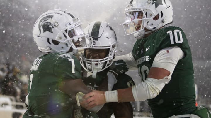 Nov 27, 2021; East Lansing, Michigan, USA; Michigan State Spartans wide receiver Jayden Reed (1) celebrates with running back Kenneth Walker III (9) and quarterback Payton Thorne (10) after making a touchdown catch during the fourth quarter against the Penn State Nittany Lions at Spartan Stadium. Mandatory Credit: Raj Mehta-USA TODAY Sports